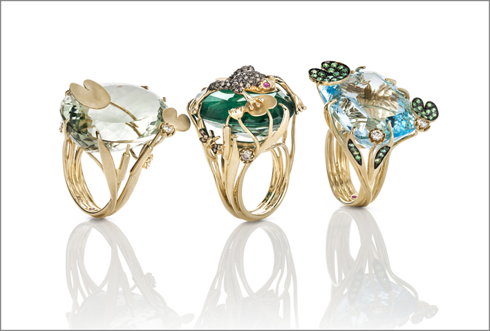 Yellow gold ring with prasiolite and white diamonds. Yellow god ring with emerald and rock crystal doublet and brown and white diamonds.  Yellow gold ring with blue topaz, natural green garnet and white diamonds