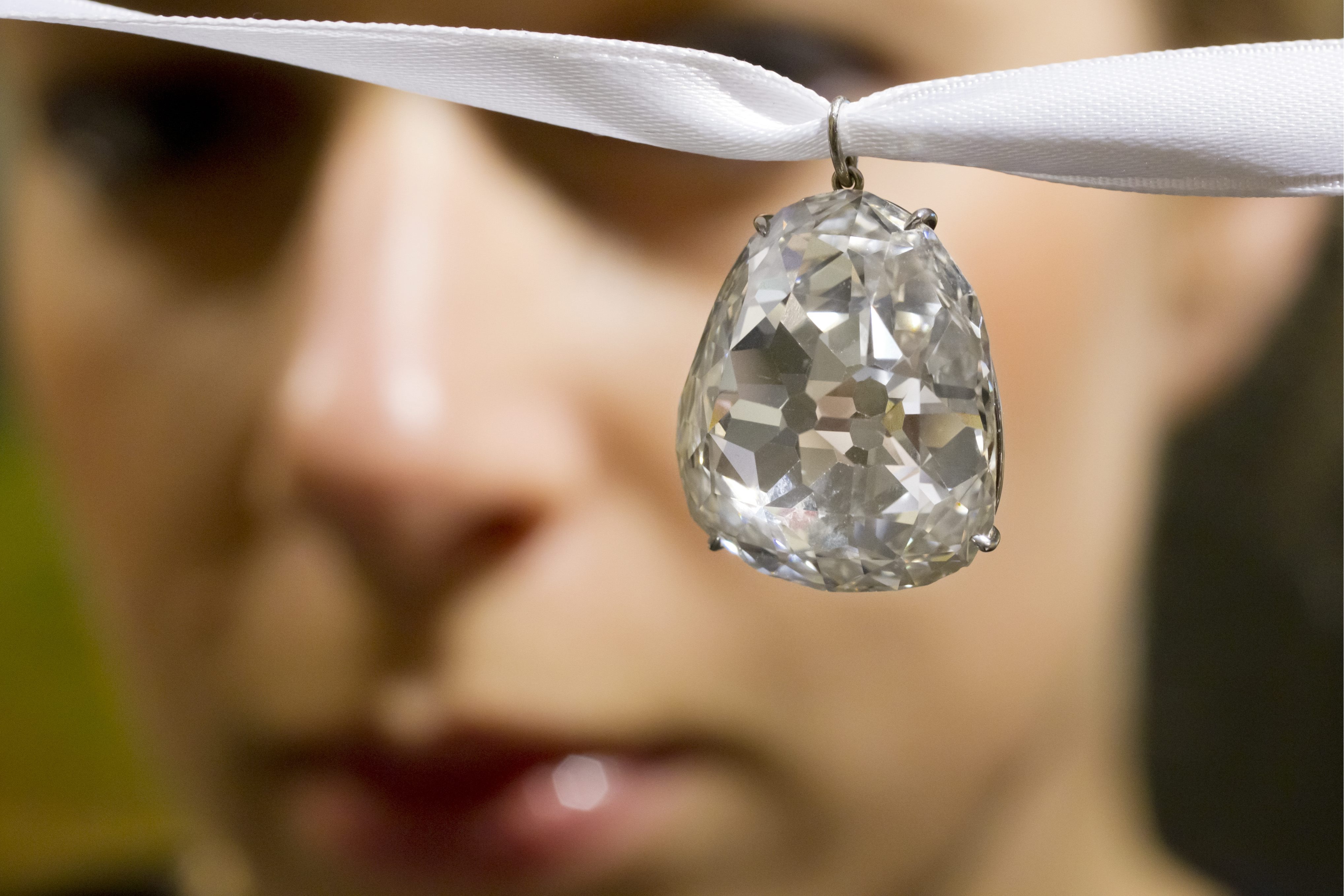 FILE - In this May 2, 2012 file photo an employee shows the Beau Sancy diamond, 34.98 carat,  at Sotheby's auction house in Zurich, Switzerland. Marie de Medici wore it at her coronation as Queen Consort of Henry IV in 1610, and now the Beau Sancy diamond is a lavish accessory owned by an anonymous bidder who paid  US $9.7 million  (7.6 million euro) for it at Sothebys auction in Geneva  Tuesday May 15, 2012. The spring auction season for jewelry and watches is upon Geneva, where elegant lakefront hotels fill with well-heeled buyers and bidders in a scene far removed from the debate over European austerity.   (AP Photo / Keystone, Alessandro Della Bella, File)