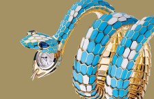 Sapphires shine in the eyes of this Bulgari turquoise and white enamel snake bracelet 1967. A round watch is revealed in the serpents mouth