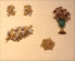 Gianmaria Buccellati 1992
orecchini e spilla a rametto di quercia in oro giallo, bianco e rosa con perle e diamanti; spilla con vaso in smeraldoinciso e 8 rubini cabochon; spilla in oro giallo traforato e zircone gatteggiante
