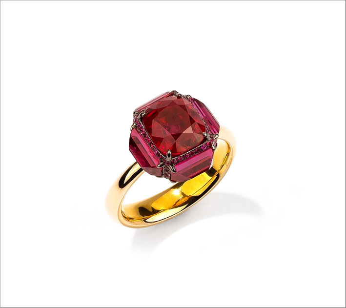 18k yellow gold ring is set with one cushion shaped Burma ruby weighing 3.38 cts and four cushion shaped rubies weighing 2.70 cts